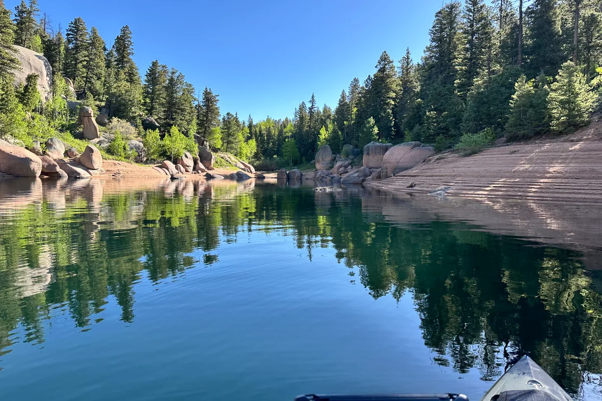 Kayaking through a granite cove at Rampart Reservoir